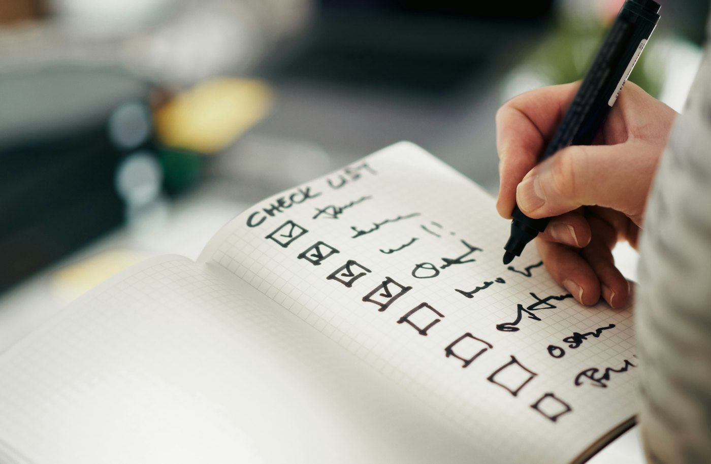 Someone marking items off a printed checklist