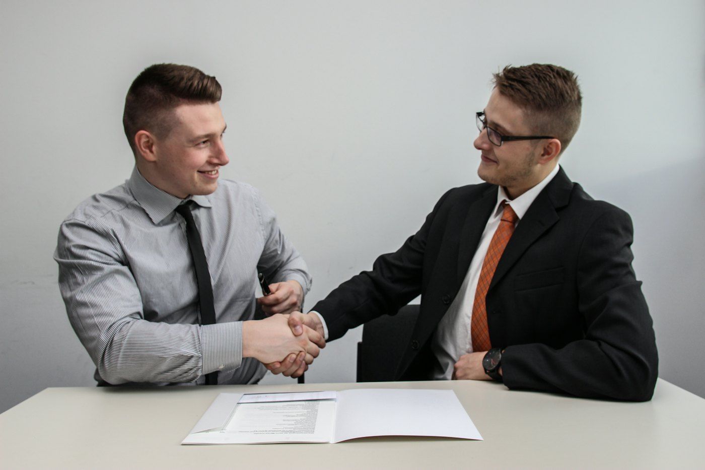Two people shaking hands at the end of a meeting