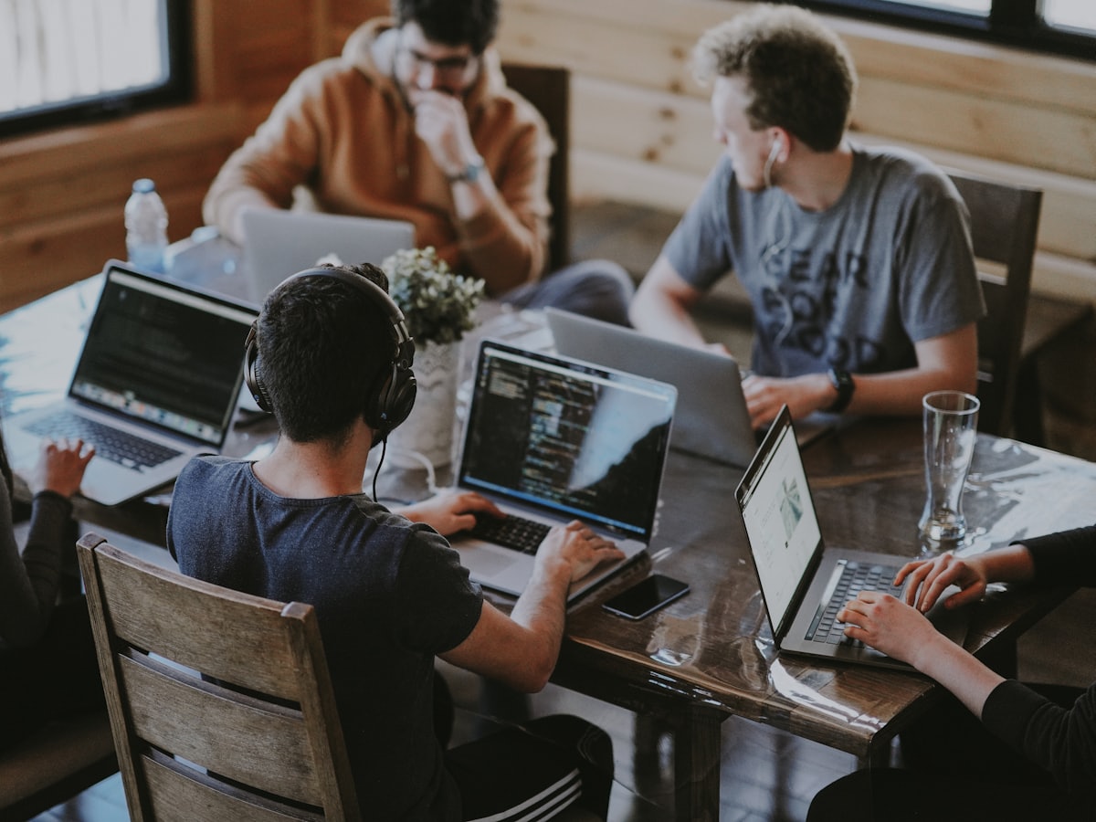 A marketing team collaborating around a laptop